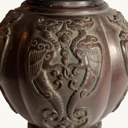 KLS Vaults Japanese Meiji period bronze vase featuring detailed relief carvings of phoenix panels in chocolate patina.