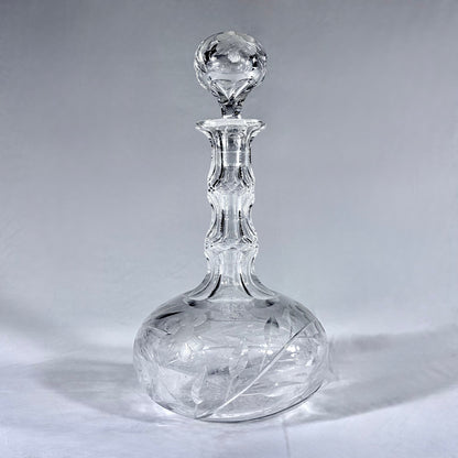 KLS Vaults mid-century lead crystal wine decanter with hand-cut floral intaglio, faceted neck, and sphere stopper.