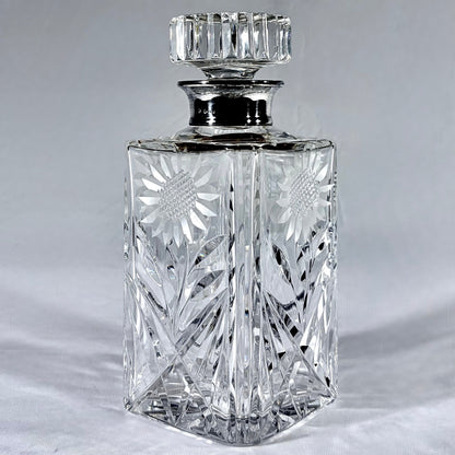 KLS Vaults mid-century cut-glass decanter with sterling silver collar, sunflower engraving, and faceted stopper.