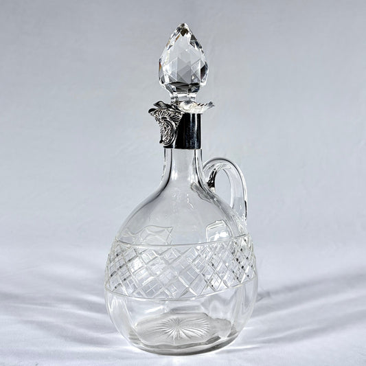 KLS Vaults Edwardian crystal claret jug with diamond-cut body, silver mount, and faceted teardrop stopper.