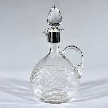 KLS Vaults Edwardian crystal claret jug with diamond-cut pattern, silver mount, and faceted teardrop stopper.