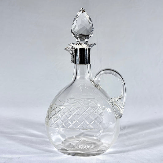 KLS Vaults Edwardian crystal claret jug with diamond-cut pattern, silver mount, and faceted teardrop stopper.