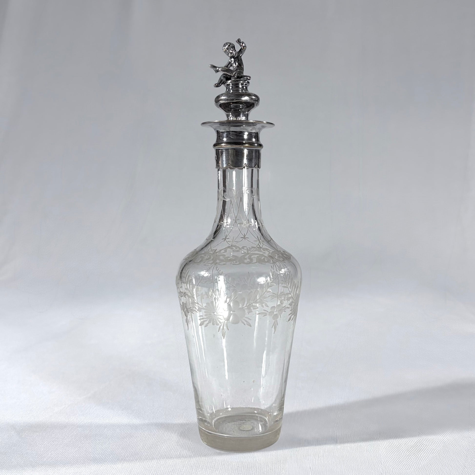 KLS Vaults Edwardian glass liqueur decanter with frosted floral etching and a sterling silver cherub stopper from 1902.