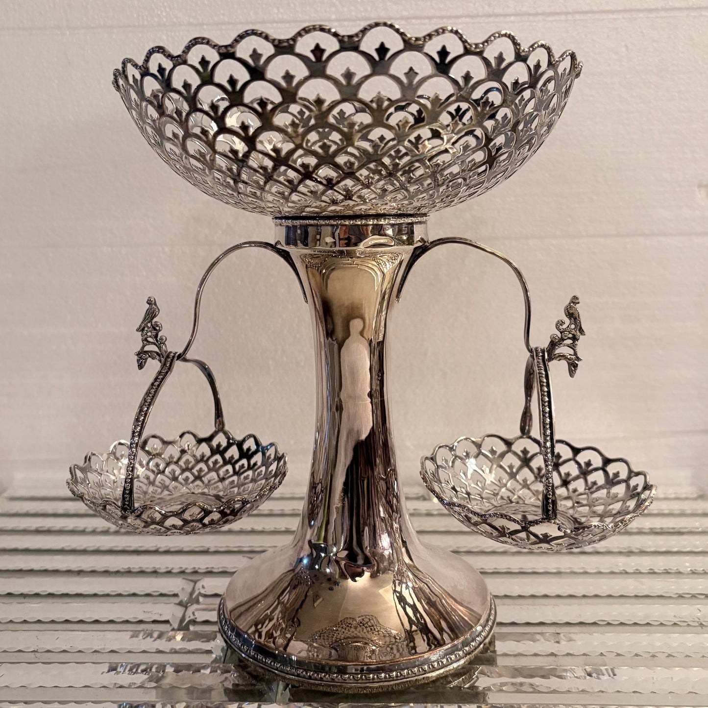 KLS Vaults Edwardian sterling silver epergne with pierced trellis-work, scalloped rims, and avian finial swing baskets.