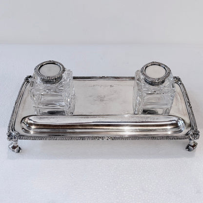 KLS Vaults Edwardian sterling silver inkstand with gadrooned border, claw-and-ball feet, and two square glass inkwells.