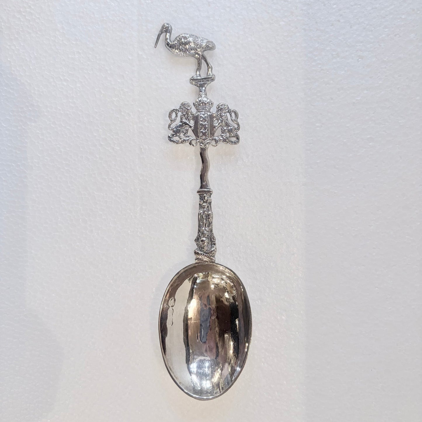 KLS Vaults 1902 Edwardian sterling silver marriage spoon with stork finial and ornate figural stem.