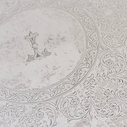 KLS Vaults sterling silver salver featuring intricate foliate scroll engraving and a central anchor armorial crest.