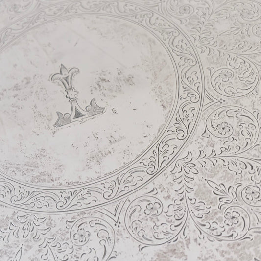 KLS Vaults sterling silver salver featuring intricate foliate scroll engraving and a central anchor armorial crest.