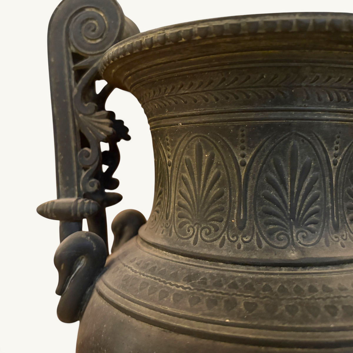 KLS Vaults 19th-century French urn featuring dark Pompeian patina, swan-neck volute handles, and palmette relief details.