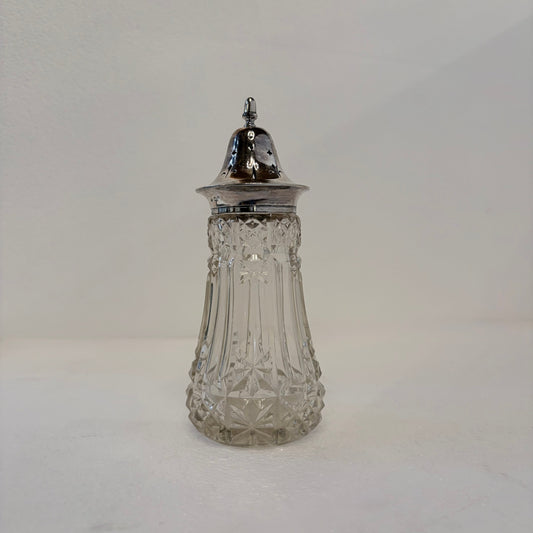 KLS Vaults 1915 George V sugar sifter with star-cut glass body and ornate sterling silver pierced lid.