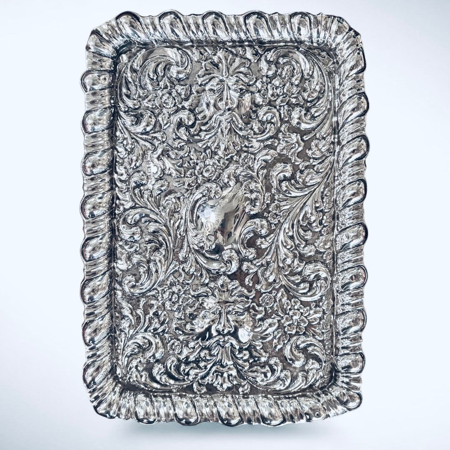 KLS Vaults 1927 George V sterling silver dressing tray with ornate repoussé floral scrolls and Green Man mask motifs.