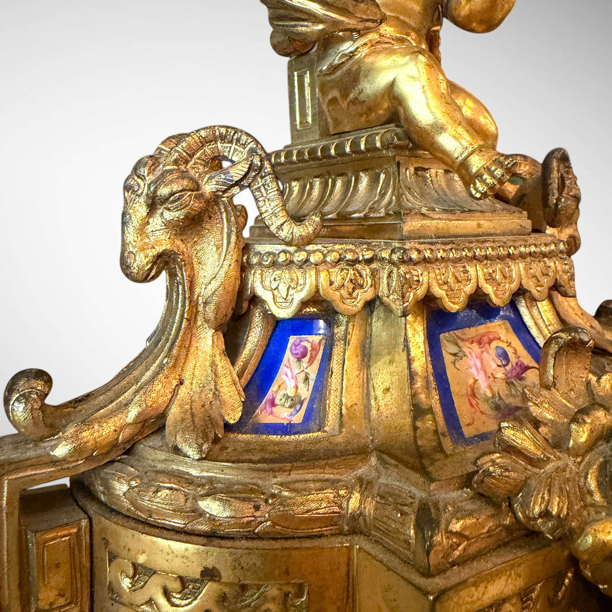 KLS Vaults gilt-bronze candelabra base featuring a seated putto, bleu céleste Sèvres-style porcelain, and ram's heads.