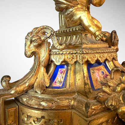KLS Vaults gilt-bronze candelabra base featuring a seated putto, bleu céleste Sèvres-style porcelain, and ram's heads.