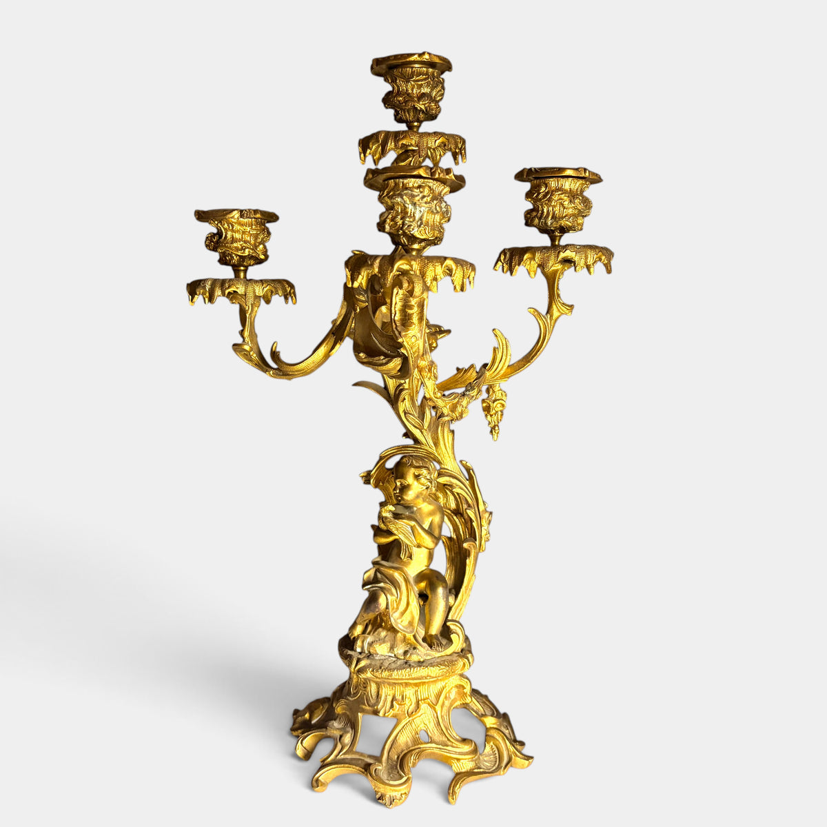 KLS Vaults 19th-century Louis XV style gilt bronze four-light candelabrum featuring a putto and acanthus foliage.