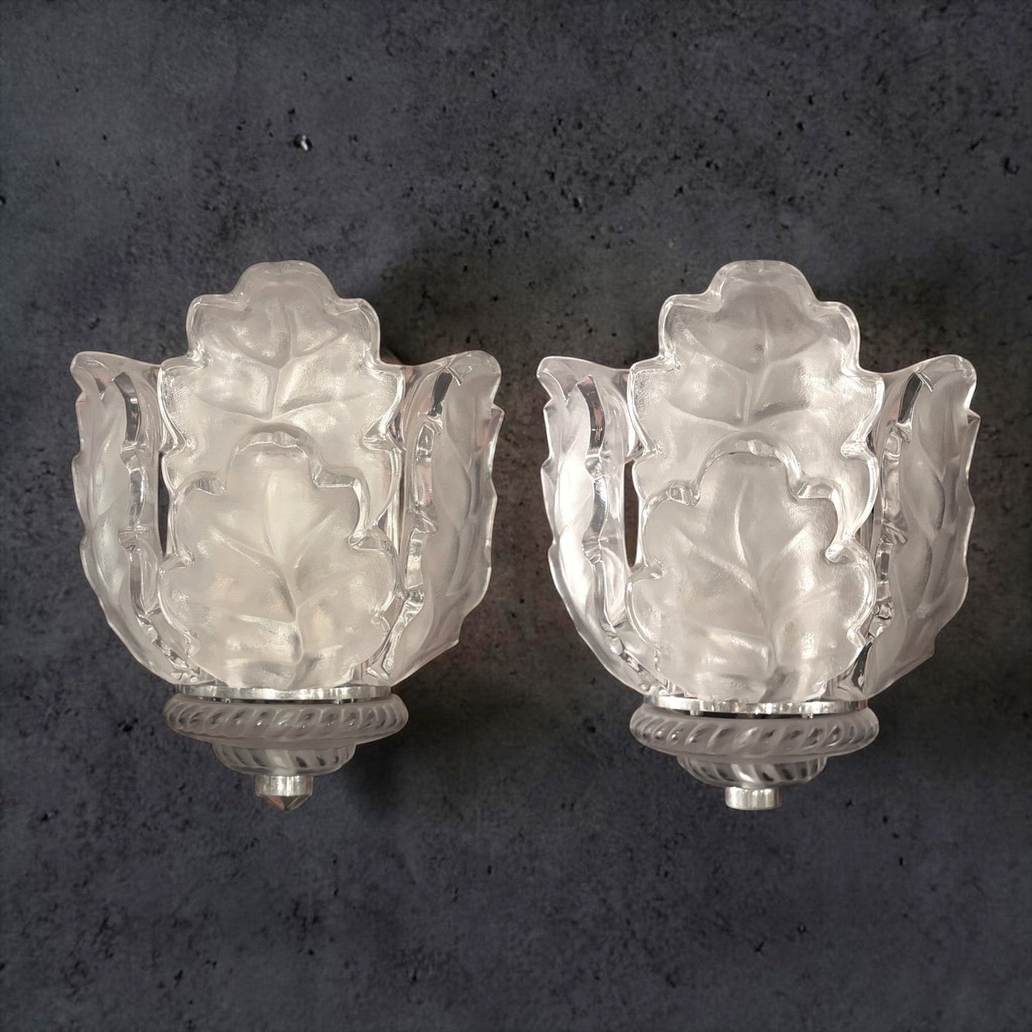 KLS Vaults pair of Lalique Chene oak leaf wall sconces in clear and frosted crystal with chrome rope-twist mounts.