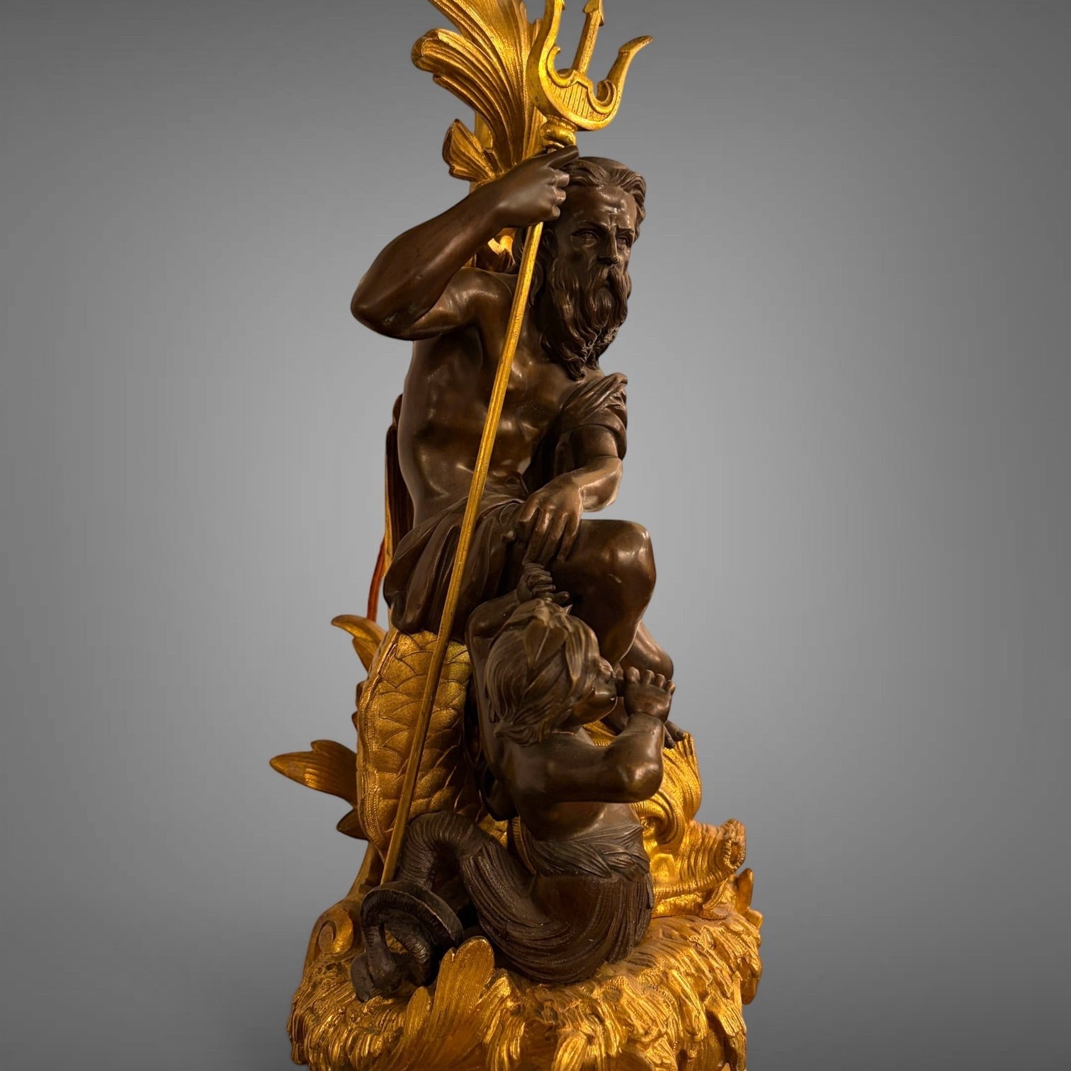 KLS Vaults antique French gilt bronze candelabra featuring Neptune and Triton figures with ornate sea foam detailing.