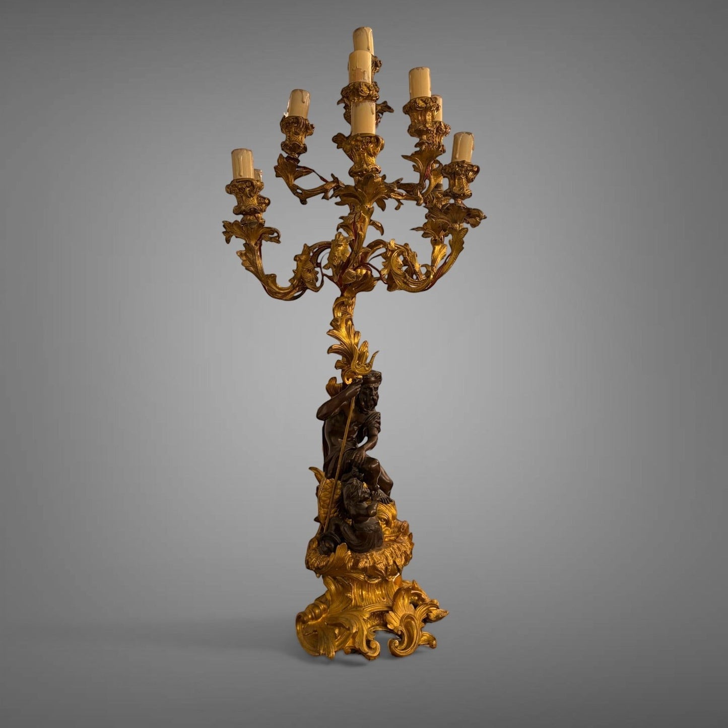 KLS Vaults 19th-century French gilt bronze and patinated bronze nine-light candelabra featuring Neptune and Triton.