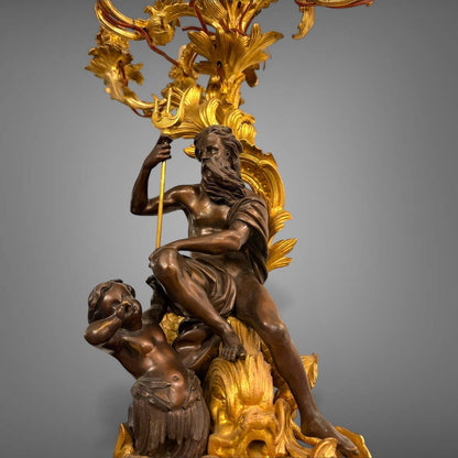 KLS Vaults 19th-century French gilt bronze candelabra featuring Neptune and Triton figures with foliate scroll arms.