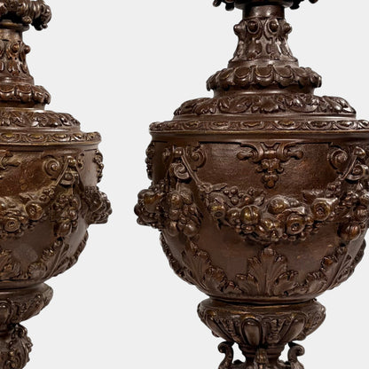 KLS Vaults pair of 19th-century Rococo Revival patinated bronze ewers with intricate floral and fruit relief garlands.