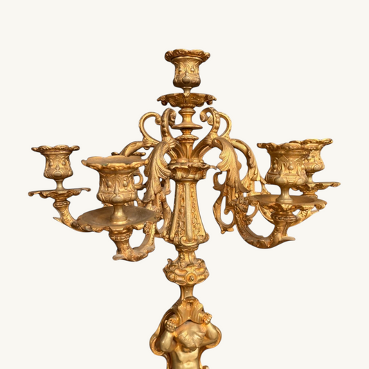 KLS Vaults pair of 1870 French Rococo revival gilt bronze five-light candelabra with putto figure and acanthus detail.