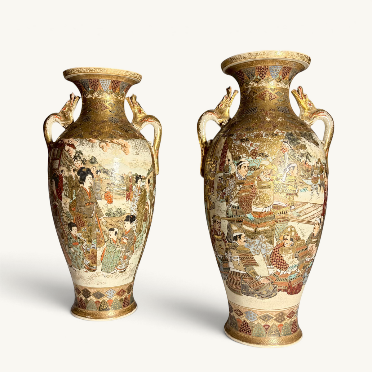 KLS Vaults pair of antique Japanese Satsuma vases with gilt dragon handles, depicting court ladies and samurai warriors in intricate detail.