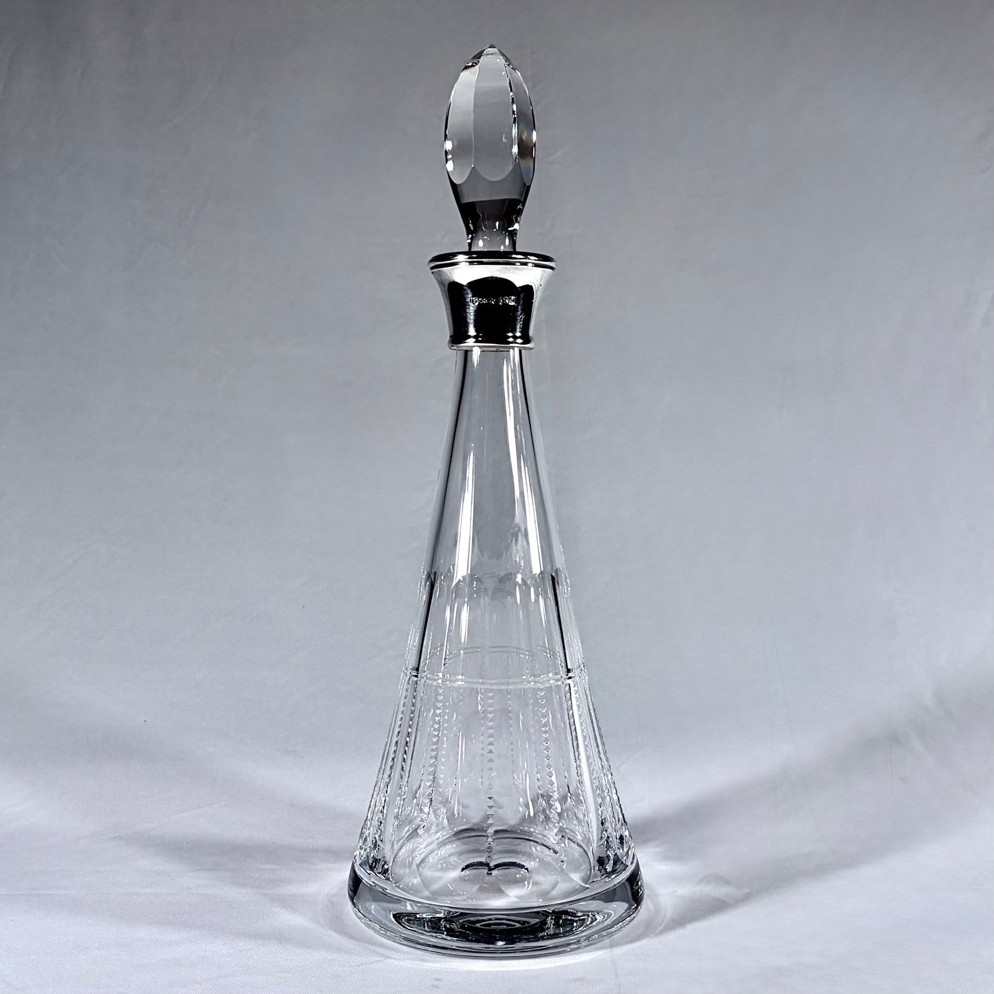 KLS Vaults Elizabeth II lead crystal conical decanter with sterling silver collar and faceted crystal stopper.