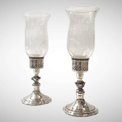 KLS Vaults pair of 1979 Elizabeth II silver hurricane lamps with pierced geometric sconces and etched glass shades.