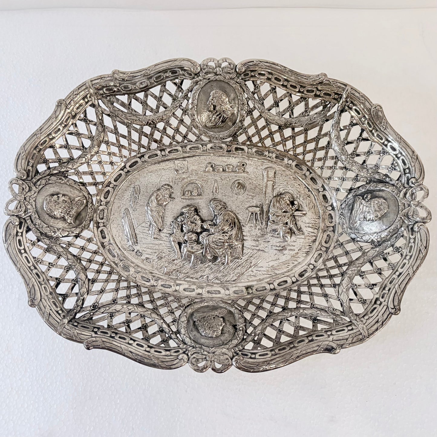 KLS Vaults 19th-century .800 silver reticulated centerpiece with repoussé tavern scene and portrait medallions.