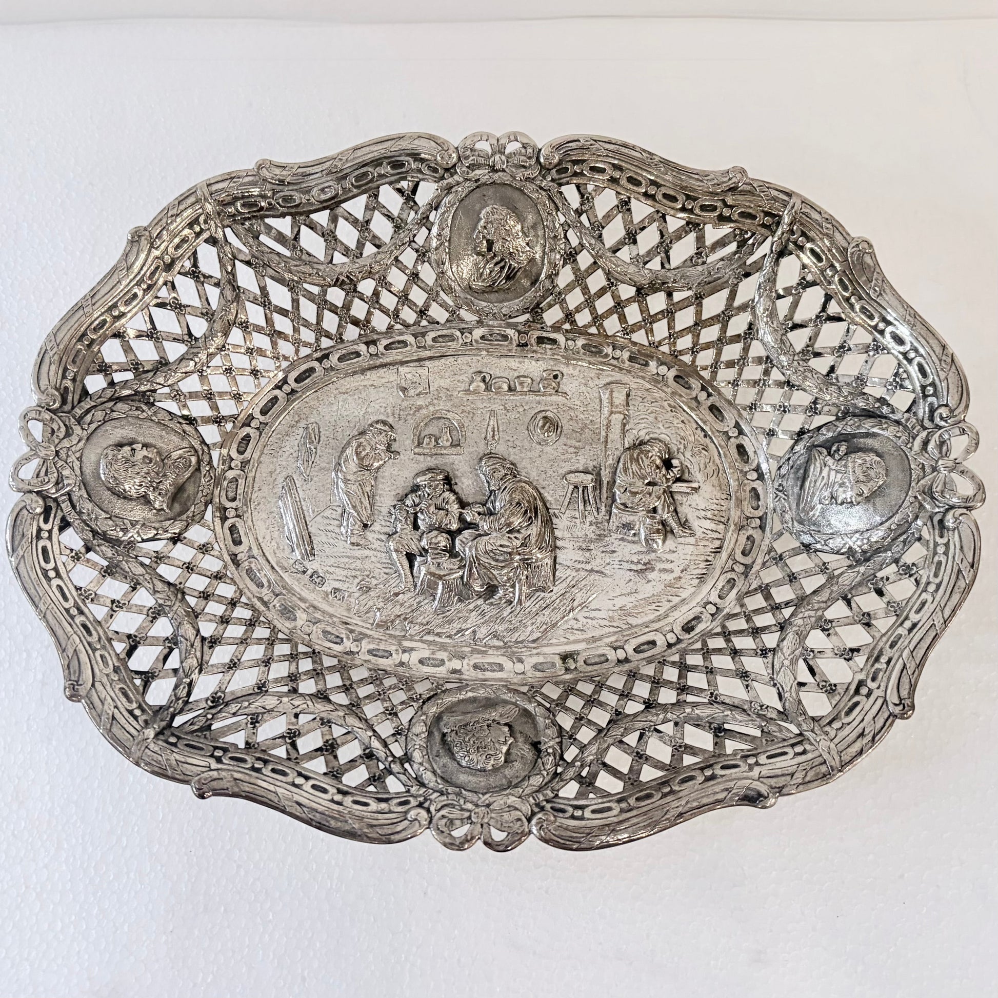 KLS Vaults 19th-century .800 silver reticulated centerpiece with repoussé tavern scene and portrait medallions.