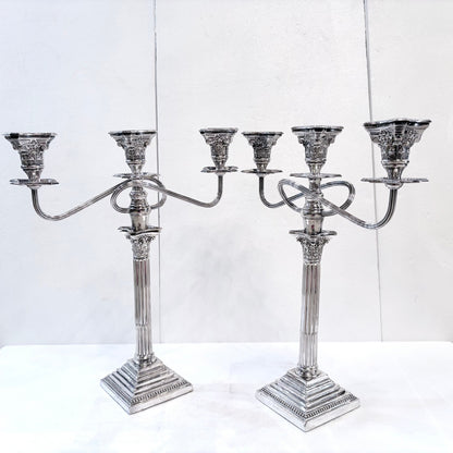 KLS Vaults pair of George III style sterling silver three-light candelabra with Corinthian columns and ornate detail.