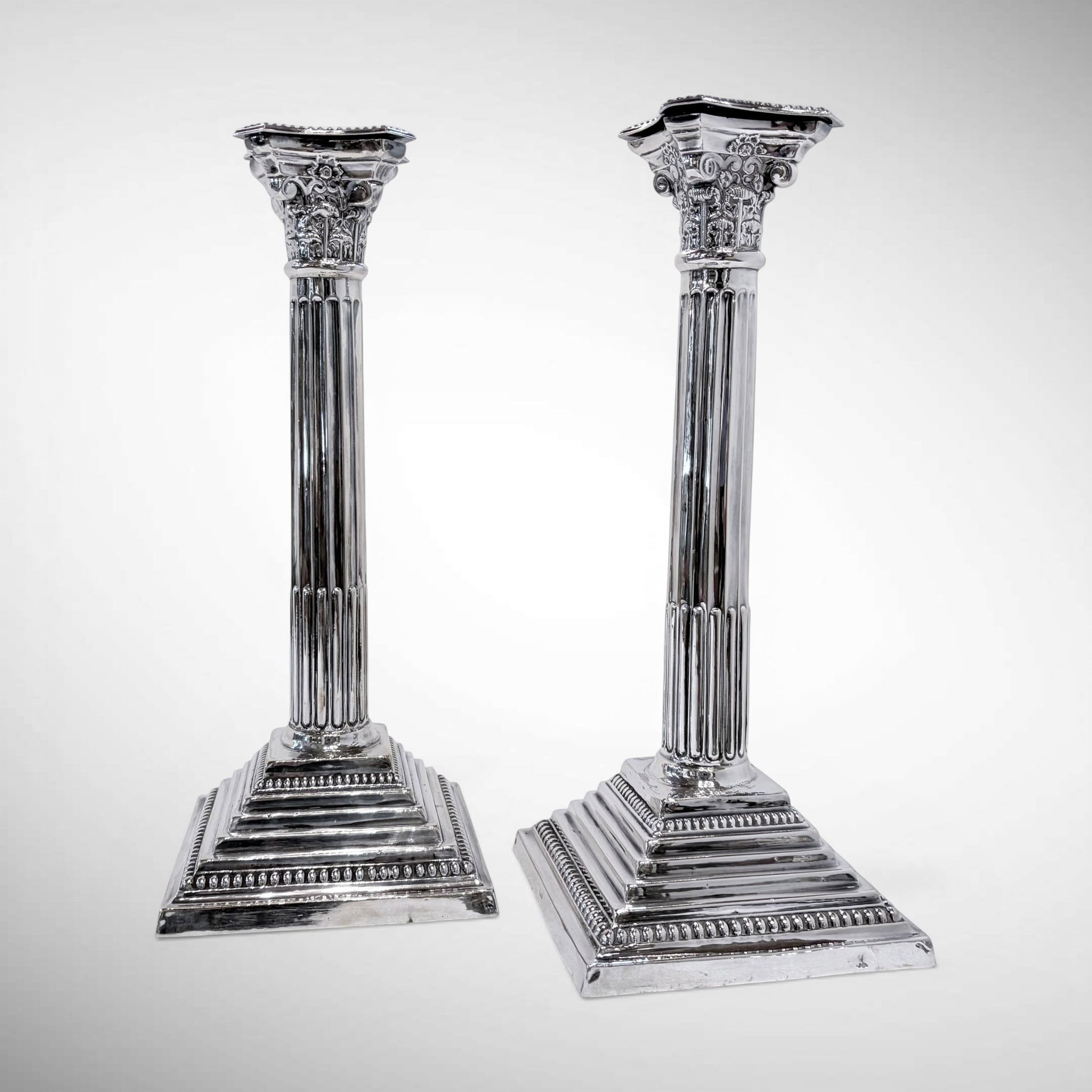 KLS Vaults pair of 1964 sterling silver Corinthian column candlesticks with fluted shafts and acanthus leaf capitals.