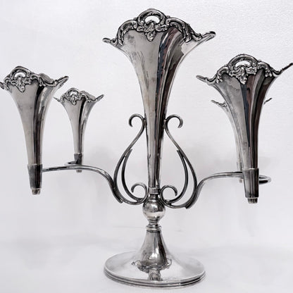 KLS Vaults Edwardian sterling silver five-trumpet epergne with ornate Rococo Revival scrolling arms, Birmingham 1909.