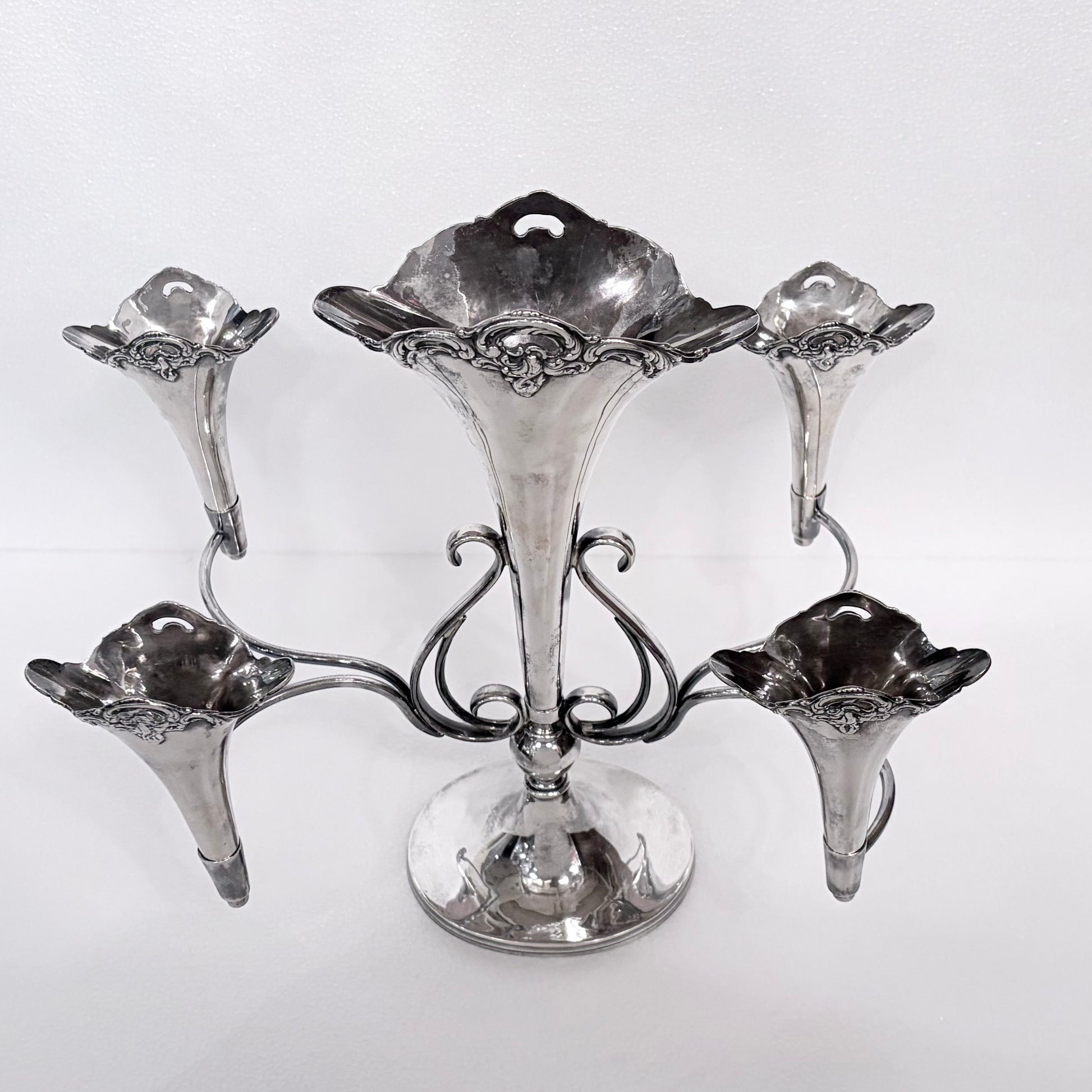 KLS Vaults Edwardian Rococo Revival sterling silver five-trumpet epergne with scrolling arms, Birmingham 1909.