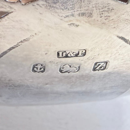 KLS Vaults sterling silver hallmark stamps including anchor, lion passant, and date letter Z on a 1949 centerpiece.