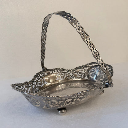 KLS Vaults Edwardian sterling silver fruit basket with intricate pierced foliate rim and lattice swing handle.