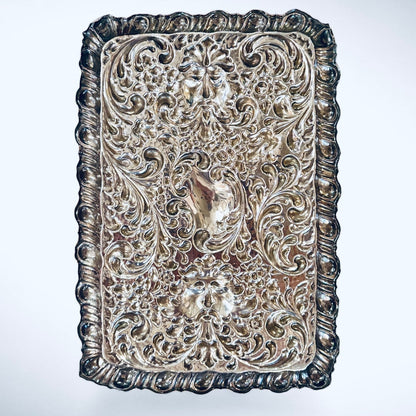 KLS Vaults 1927 George V sterling silver dressing tray with intricate repoussé floral, scroll, and Green Man mask motifs.
