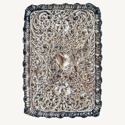 KLS Vaults 1927 George V sterling silver dressing tray with intricate repoussé floral, scroll, and Green Man mask motifs.