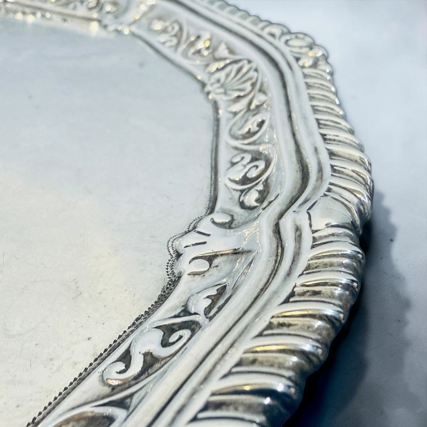 KLS Vaults sterling silver salver featuring a gadrooned rim with shell cresting and intricate rococo engraving.