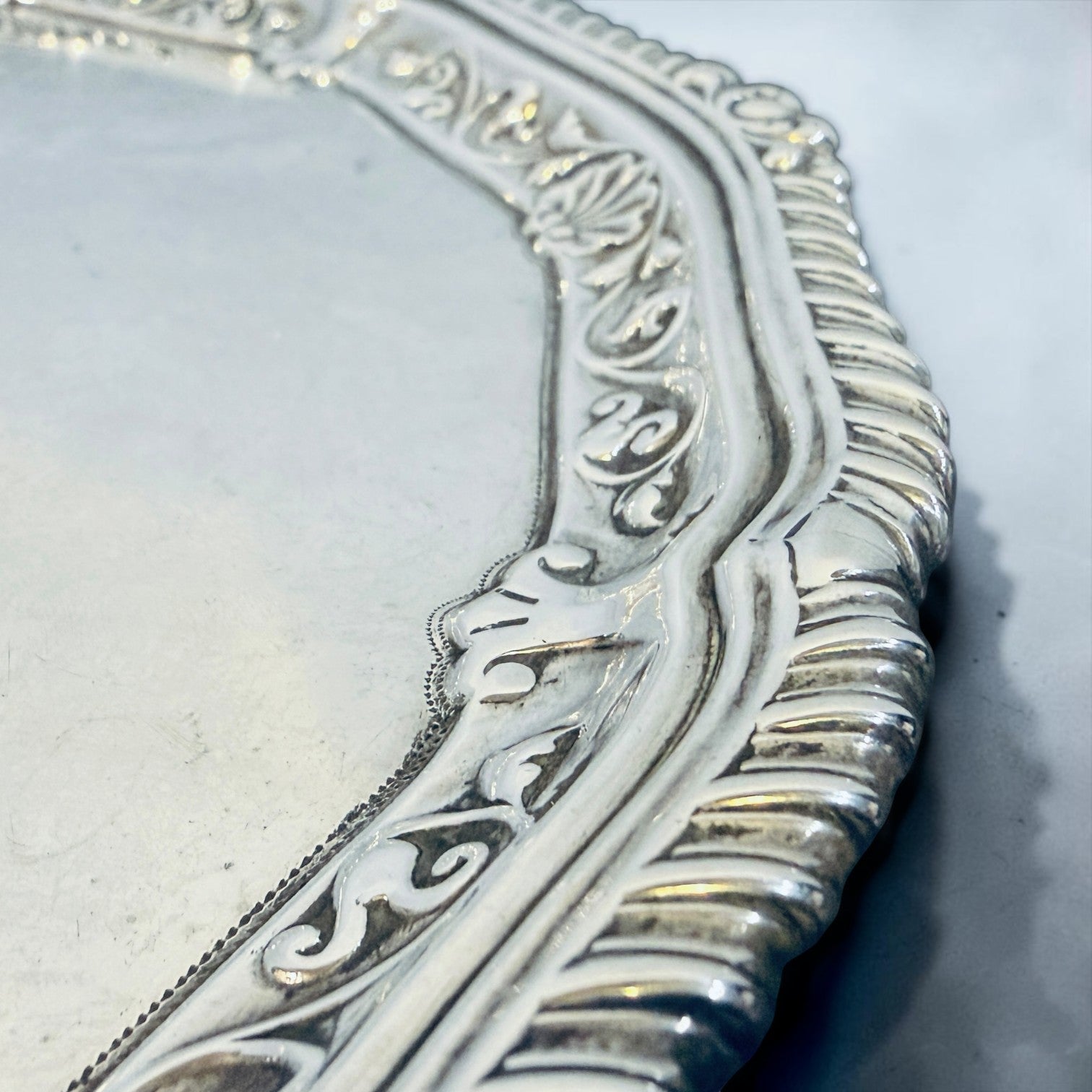 KLS Vaults sterling silver salver featuring a gadrooned rim with shell cresting and intricate rococo engraving.