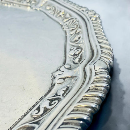 KLS Vaults sterling silver salver featuring a gadrooned rim with shell cresting and intricate rococo engraving.