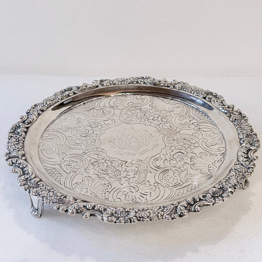 KLS Vaults 1831 William IV sterling silver salver with ornate acanthus leaf border and central armorial crest.