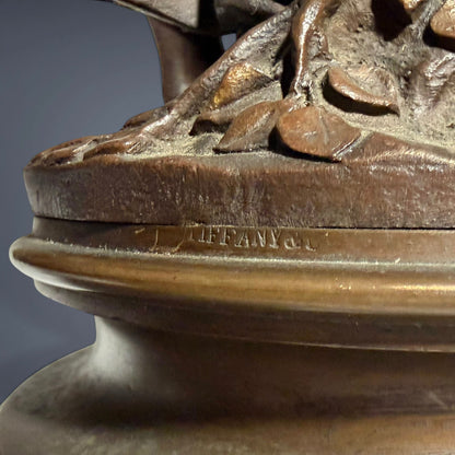 KLS Vaults patinated bronze sculpture base showing the Tiffany & Co. retail mark on a rich chocolate brown surface.