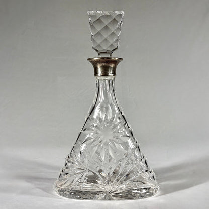 KLS Vaults triangular cut-glass decanter with sterling silver collar, floral rosettes, and geometric stopper, 1968.
