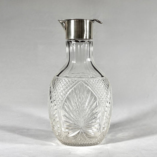 KLS Vaults Victorian claret jug with diamond-cut crystal body and sterling silver hinged lid and pouring spout.