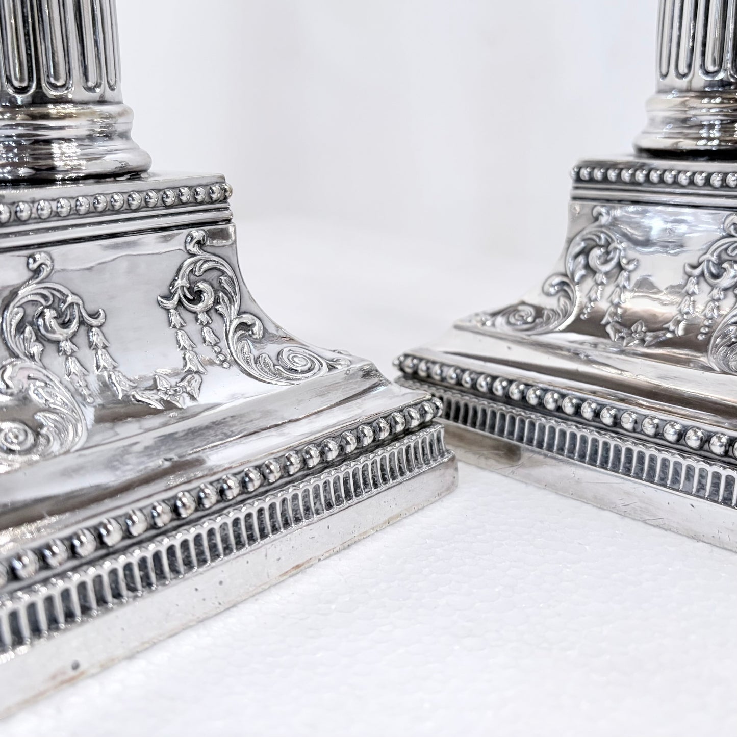 KLS Vaults pair of 1896 Victorian sterling silver Corinthian column candlesticks with ornate beaded square bases.