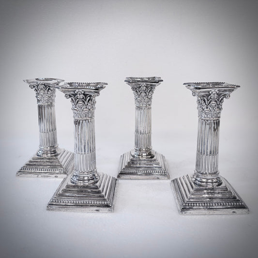 KLS Vaults set of four Victorian sterling silver Corinthian column candlesticks with acanthus leaf capitals.