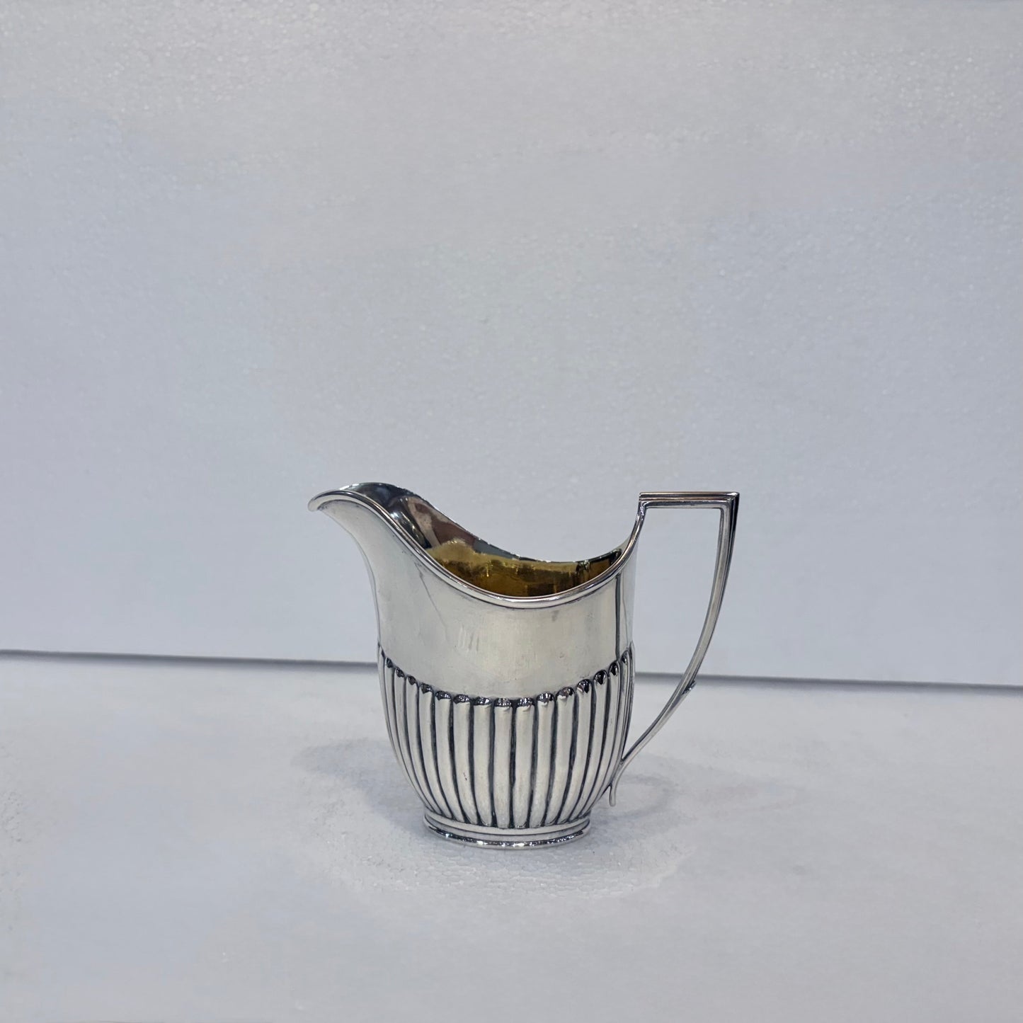 KLS Vaults Victorian sterling silver cream jug with vertical fluting and a gilt interior, hallmarked London 1878.