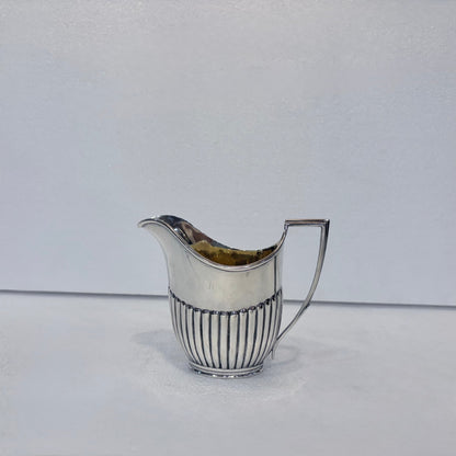 KLS Vaults Victorian sterling silver cream jug with vertical fluting and a gilt interior, hallmarked London 1878.