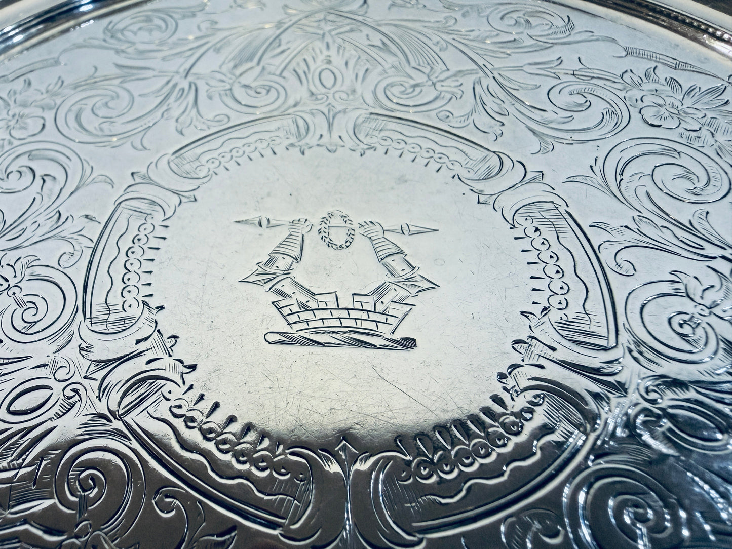 KLS Vaults Victorian sterling silver salver featuring intricate chased acanthus leaf patterns and a central crest.