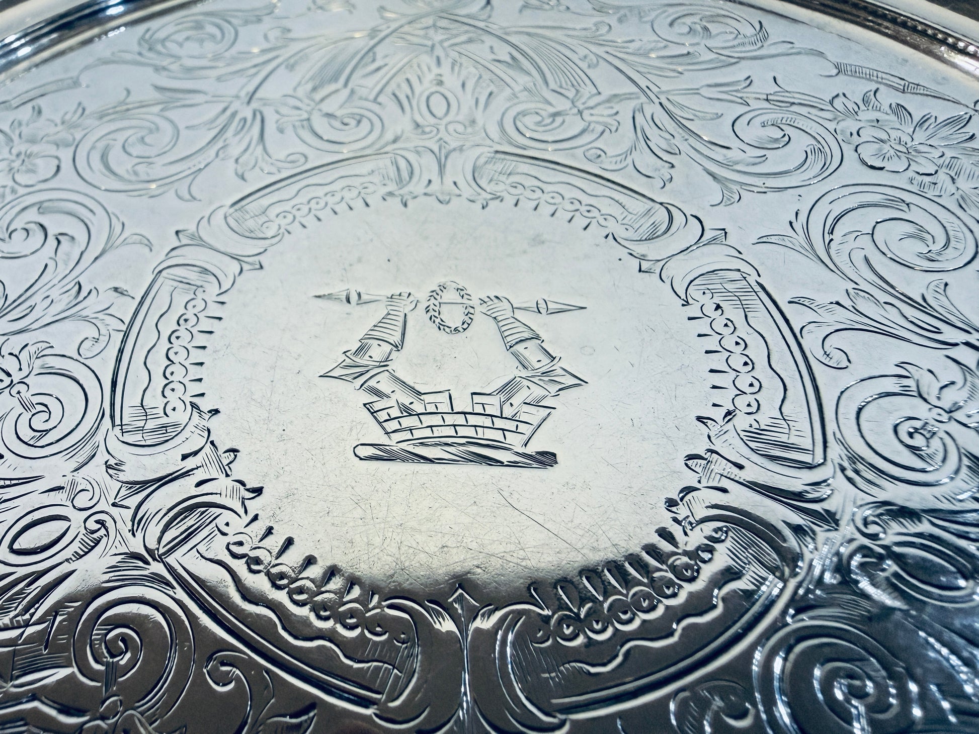 KLS Vaults Victorian sterling silver salver featuring intricate chased acanthus leaf patterns and a central crest.